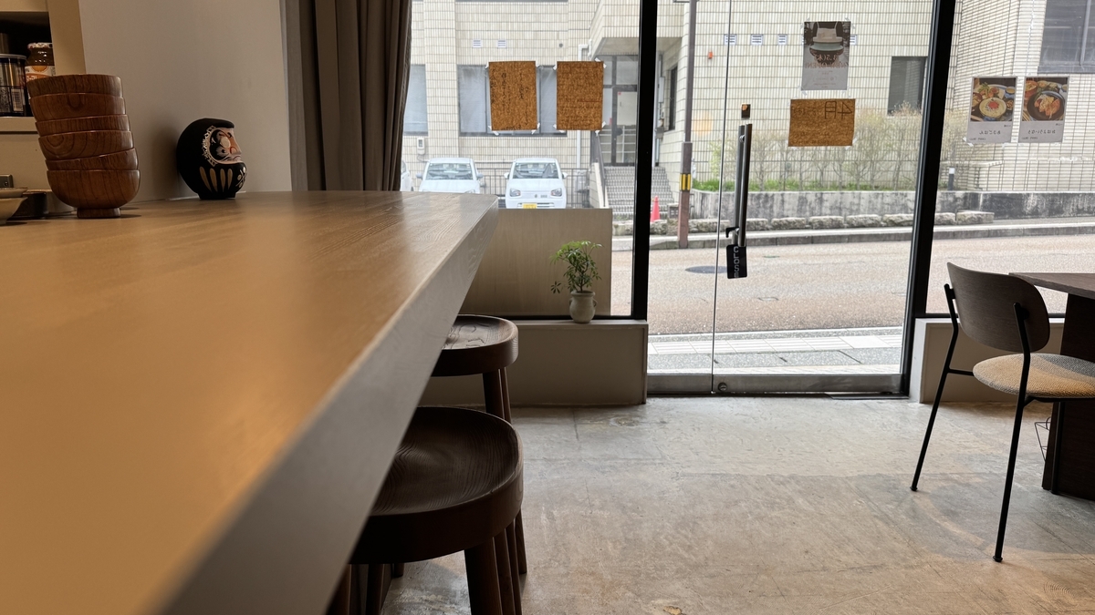 View from the counter looking toward the glass entrance of Komejirushi