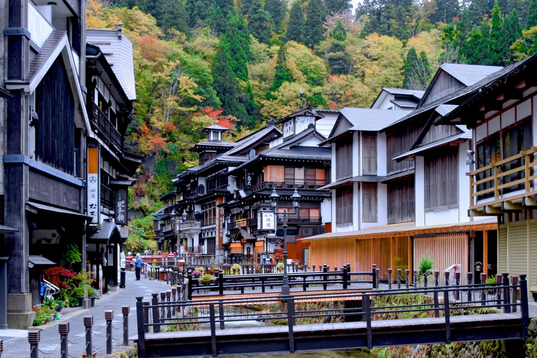 Wooden ryokan inns lining the river in Ginzan Onsen town