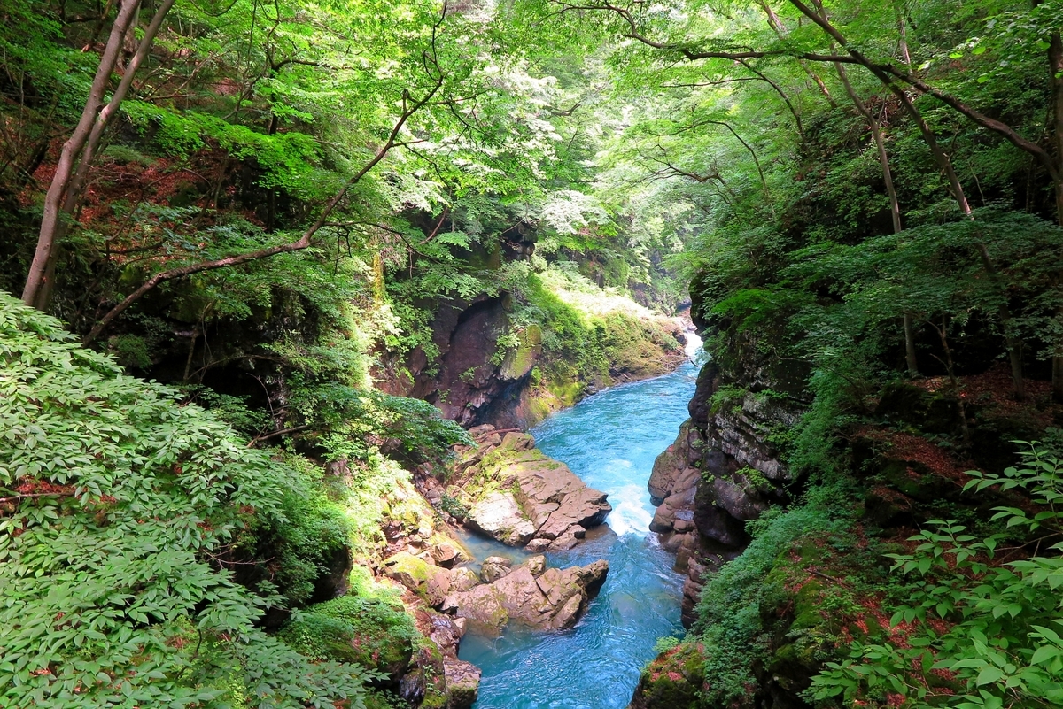 El agua azul de la garganta de Agatsuma fluyendo cerca de Kawanaka Onsen