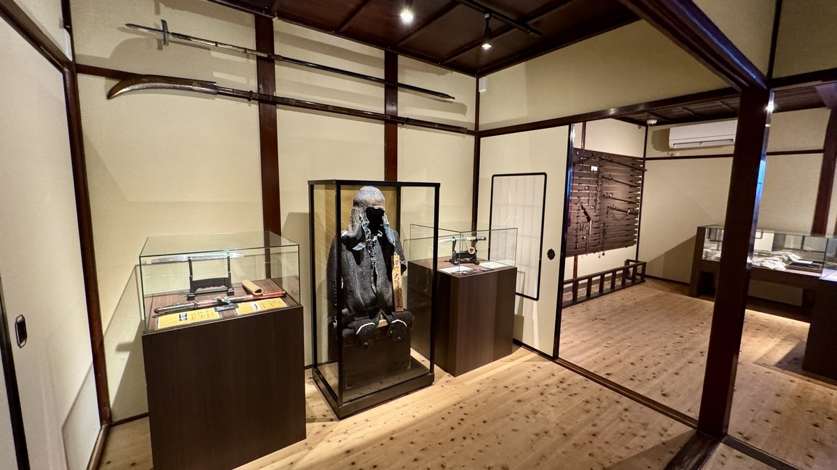 A room of ninja gear displaying chainmail and long-handled weapons