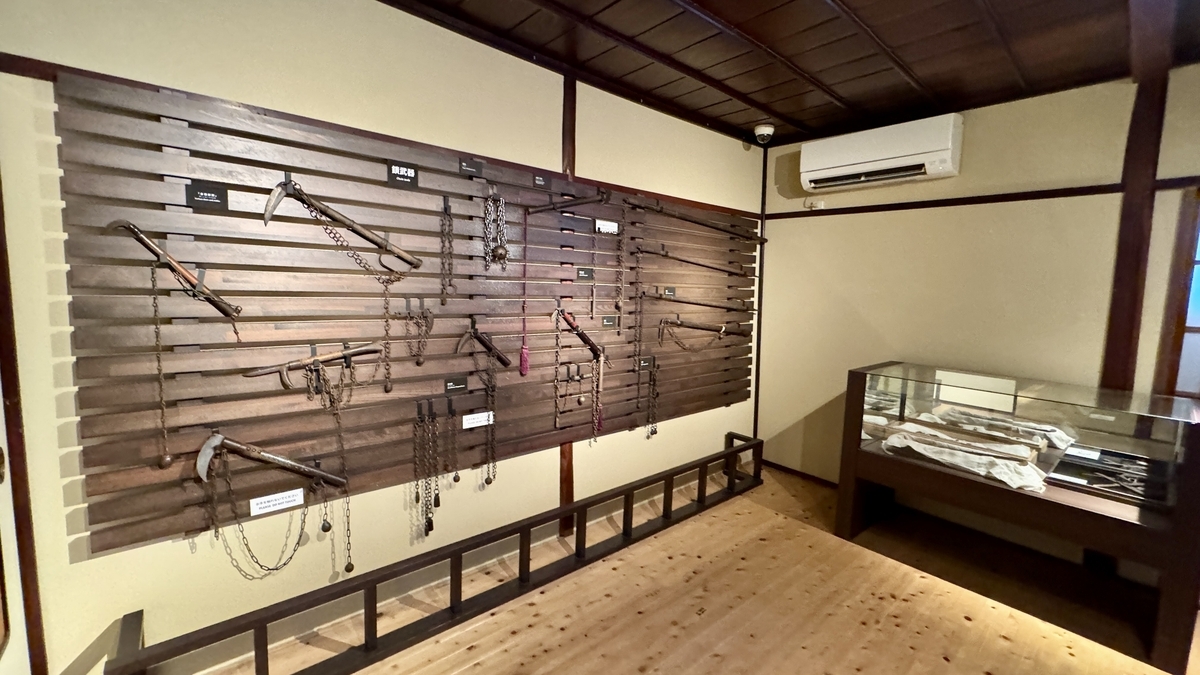 A wall display lined with kusarigama and long ninja weapons