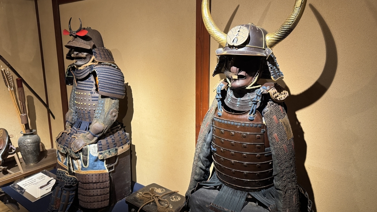 A close-up of armor with a helmet bearing large horn-shaped crests
