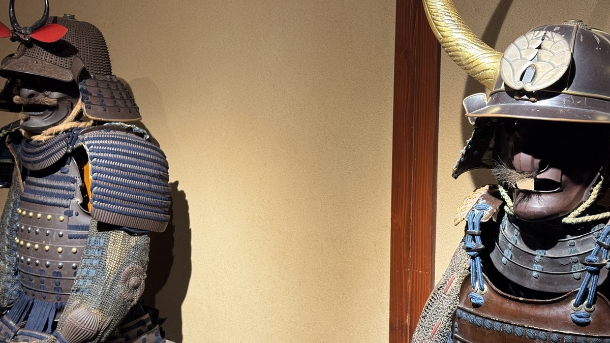 A close-up of two suits of armor wearing different helmets