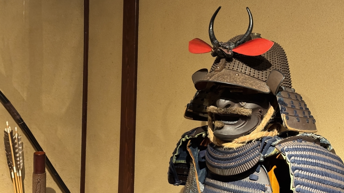 Armor with a red-crested helmet and a face guard