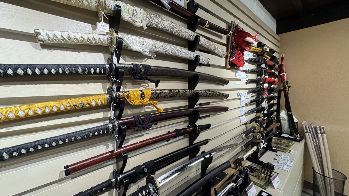 Sales shelves lined with replica katana of varying colors and decoration