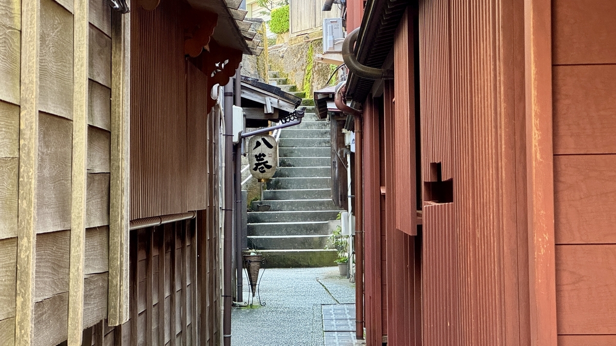 An alley in Kazuemachi Chaya District lined with machiya with noren curtains and bengara lattice